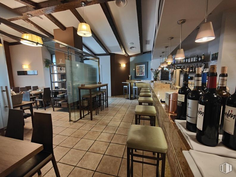 Retail for sale at Parque de los Estados, Fuenlabrada, Madrid, 28945 with lighting, wine bottle, light fixture, stool, furniture, table, bottle, chair, drinking establishment and interior design around