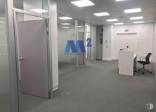 Office for rent at Parque empresarial La Moraleja, Alcobendas, Madrid, 28108 with door, chair, light fixture, lighting, flooring, floor, interior design, ceiling, glass and composite material around