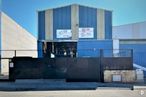 Industrial for sale at Poligono Alcamar, Camarma de Esteruelas, Madrid, 28816 with building, sky, asphalt, material property, facade, composite material, commercial building, rectangle, gas and tints and shades around