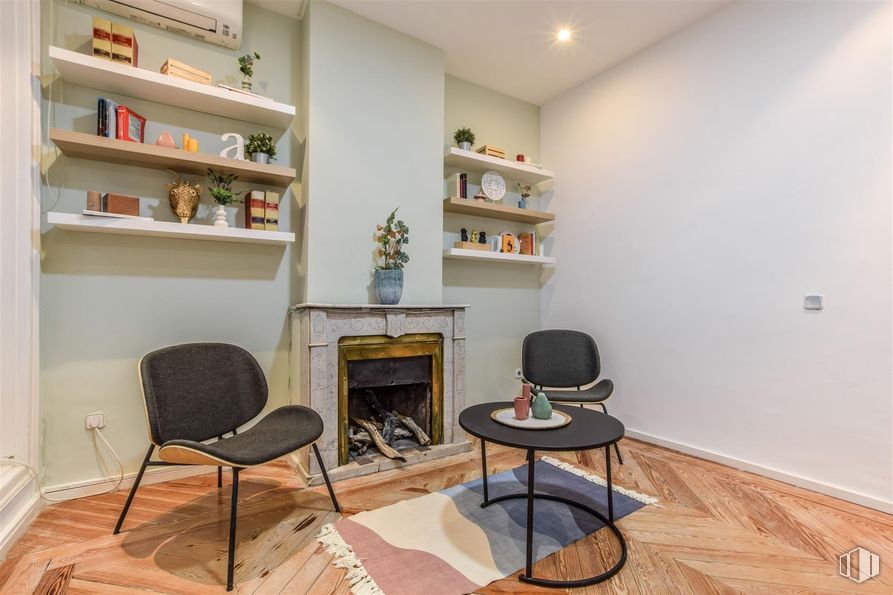 Office for rent at Calle Alfonso XII, 8, Retiro, Madrid, 28014 with chair, fireplace, coffee table, furniture, interior design, flooring, shelving, wall, bookcase and shelf around