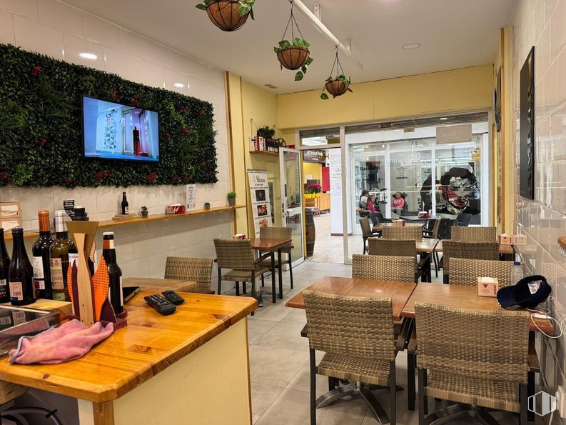 Retail for sale at Punta Galea, Las Rozas de Madrid, Madrid, 28290 with chair, television, wine bottle, light fixture, person, kitchen & dining room table, bottle, furniture, interior design and flooring around