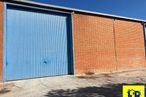 Industrial for rent at Avenida Cruz Roja, Cuenca, 16002 with door, building, property, sky, road surface, asphalt, brick, rectangle, wood and shade around