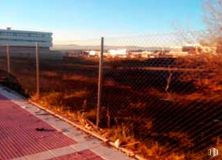 Land for sale at Avenida Tranvía, 27, Alcorcón, Madrid, 28925 with building, sky, fence, asphalt, road surface, grass, wood, road, landscape and brick around