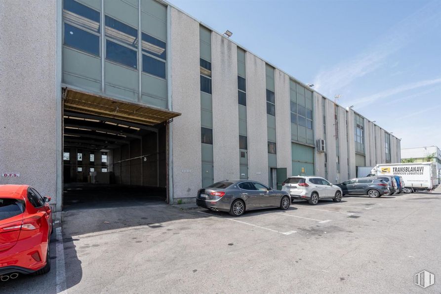 Industrial for sale at San Cristóbal, Villaverde, Madrid, 28021 with car, automotive parking light, wheel, land vehicle, vehicle, tire, property, building, sky and asphalt around