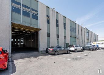 Industrial for sale at San Cristóbal, Villaverde, Madrid, 28021 with car, automotive parking light, wheel, land vehicle, vehicle, tire, property, building, sky and asphalt around