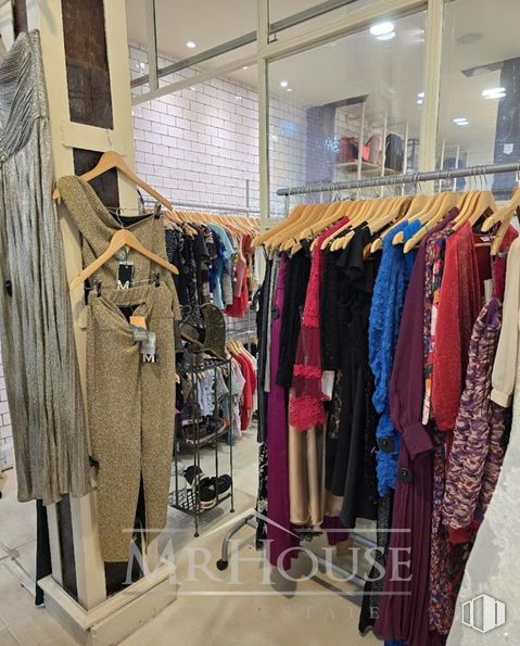 Retail for sale at Calle San Joaquín, Centro, Madrid, 28004 with outerwear, fashion, textile, clothes hanger, retail, fashion design, sportswear, building, automotive design and shelf around