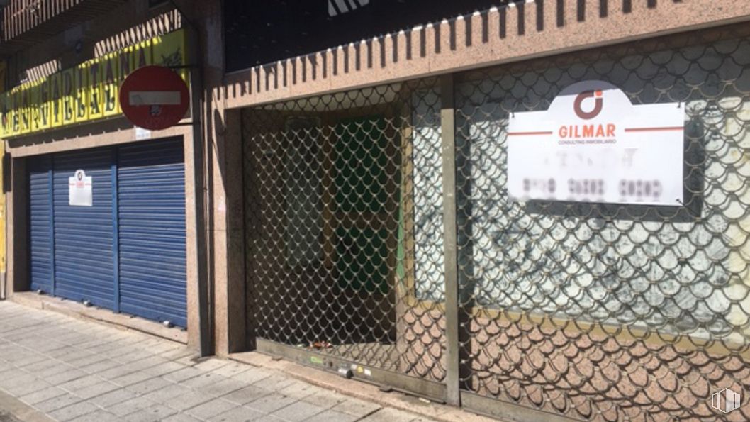 Retail for sale at Zona Centro, Collado Villalba, Madrid, 28400 with window blind, wood, asphalt, fence, mesh, road surface, gas, wire fencing, composite material and facade around