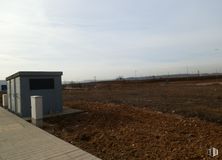 Land for sale at Zona industrial Mejorada, Mejorada del Campo, Madrid, 28840 with sky, cloud, asphalt, road surface, wood, horizon, building, landscape, road and grass around