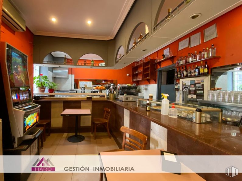 Retail for rent at Calle Hernani, 48, Tetuán, Madrid, 28020 with chair, table top, table, furniture, building, countertop, orange, interior design, cabinetry and house around